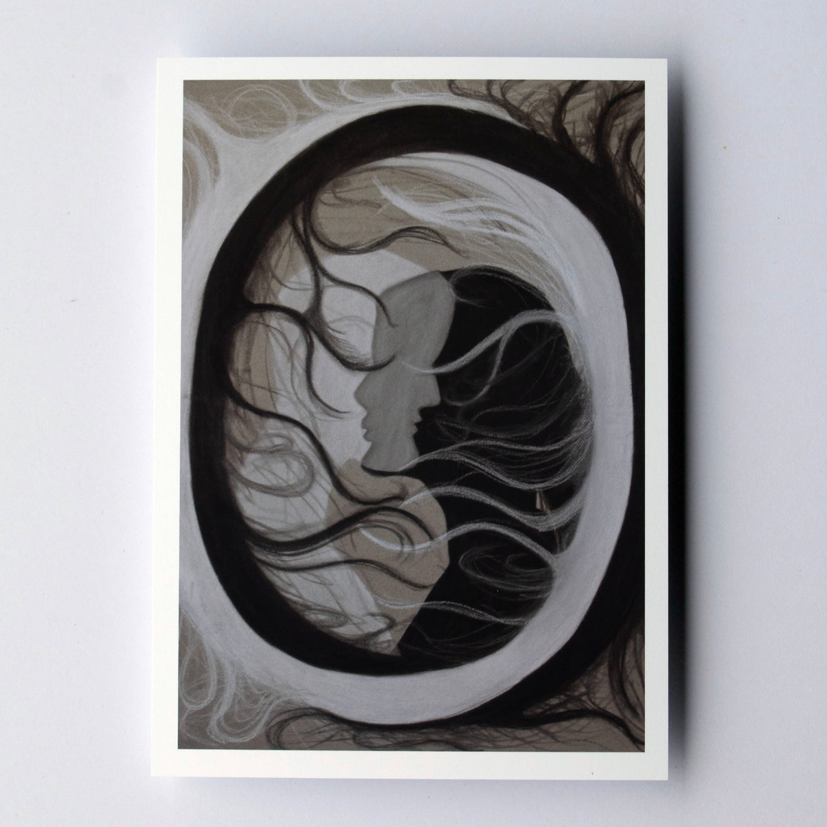 An abstract circle with black and white figures overlapping in the middle on a cream background