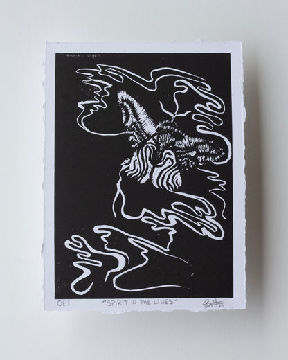 A black and white art print featuring an abstract, stylized moth with flowing line art, photographed on a light neutral background.