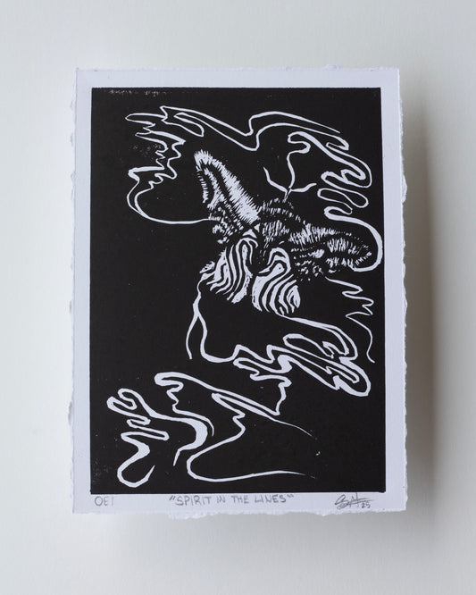 A black and white art print featuring an abstract, stylized moth with flowing line art, photographed on a light neutral background.